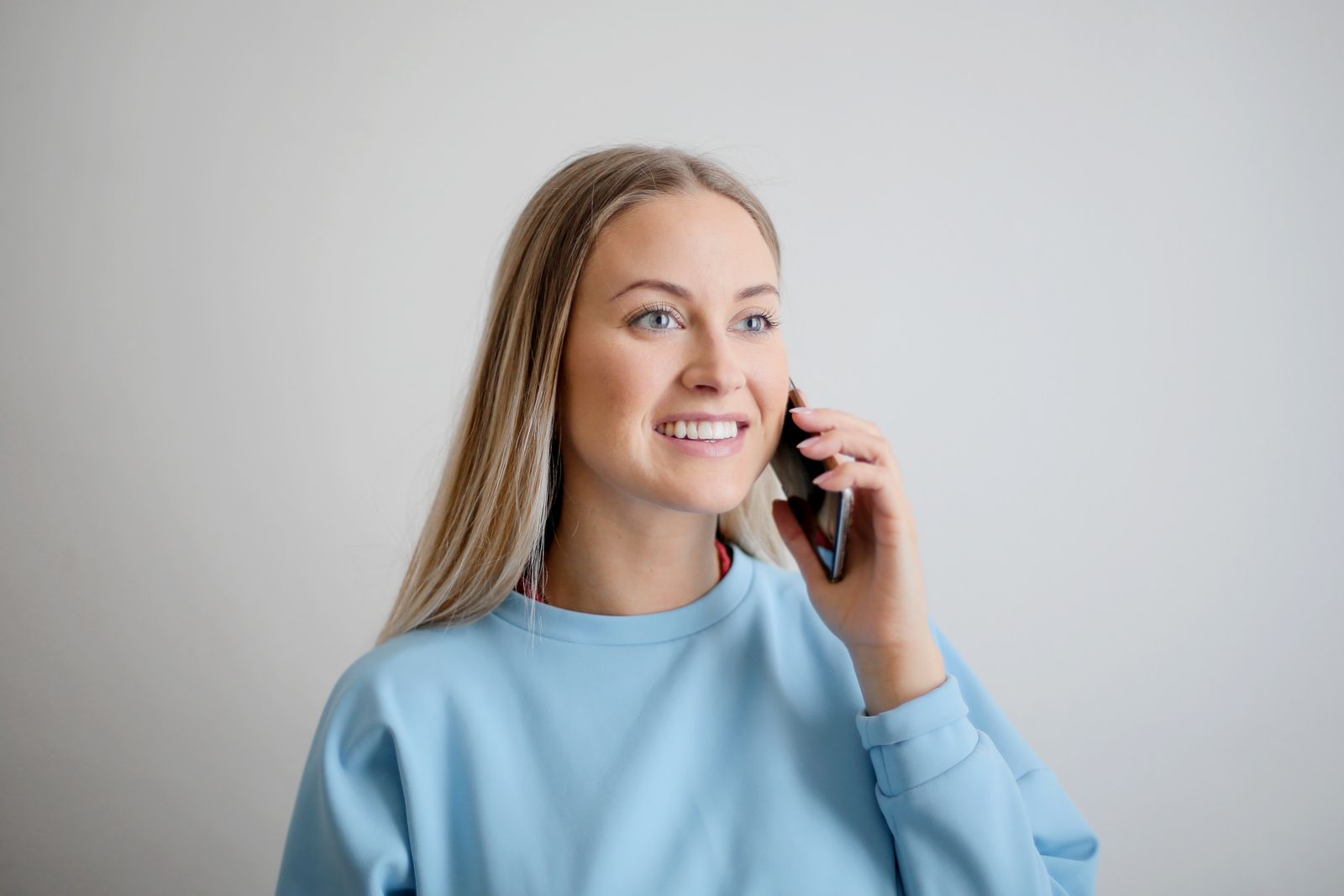 Smiling woman having a phone conversation