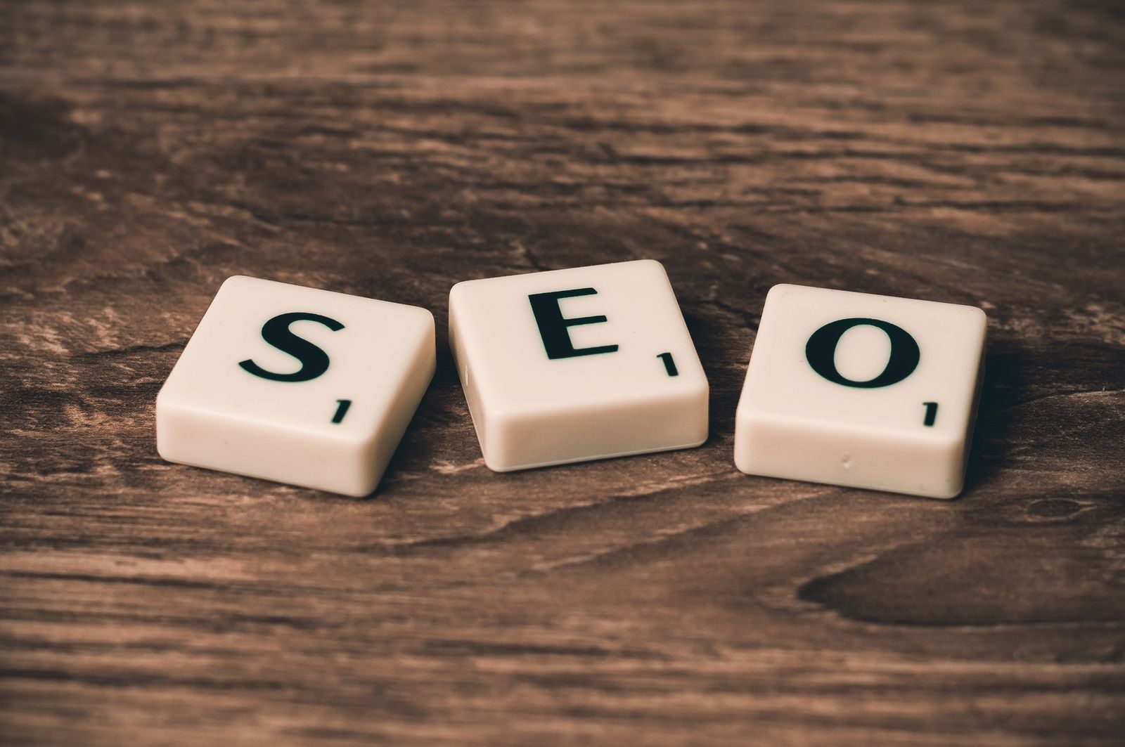 Letter tiles spelling SEO on a wooden table